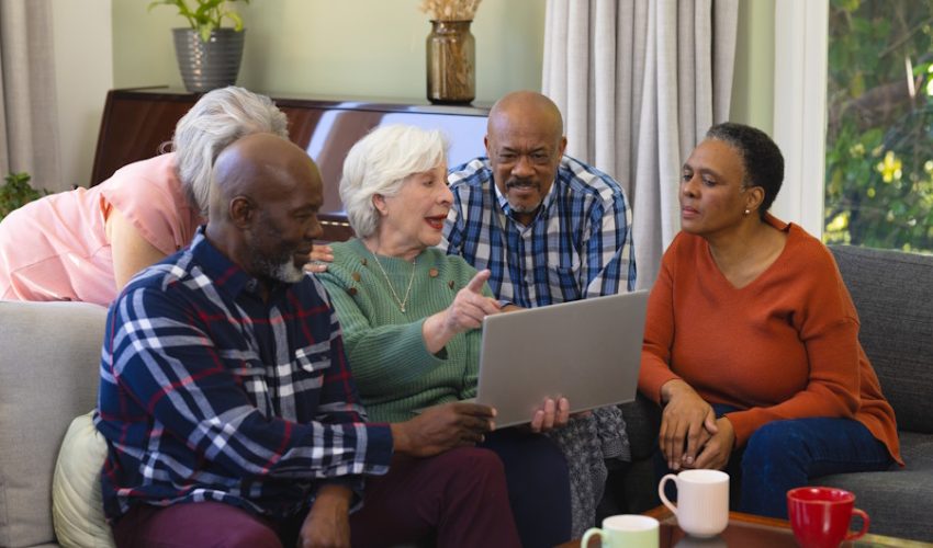 happy-diverse-group-of-senior-friends-using-laptop-w900-h600
